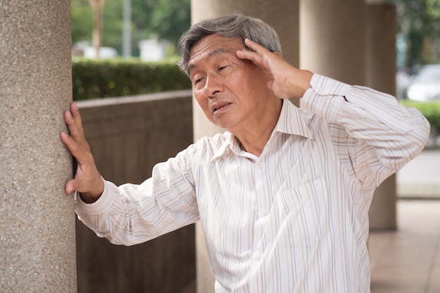 Senior old man suffering from headache