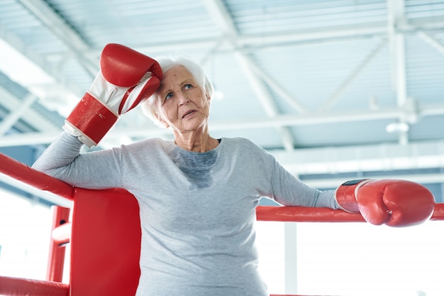 Senior old woman in boxing ring