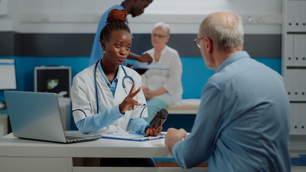 Senior patient getting prescription medicine from doctor