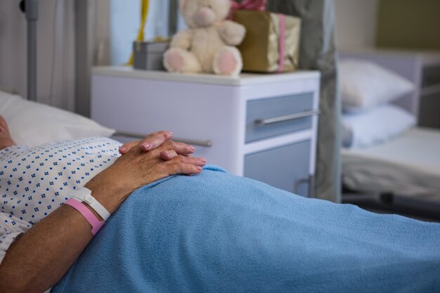 Senior patient lying on bed