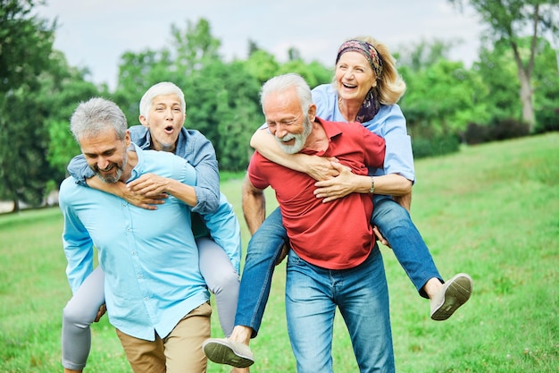 senior people couple happy elderly love together retirement man woman mature piggyback fun