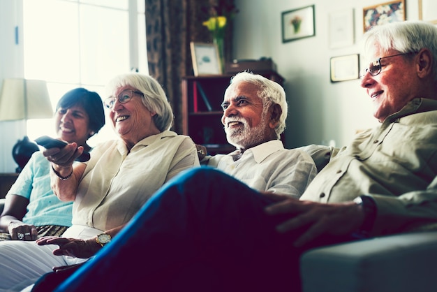 Senior people watching television in the living room