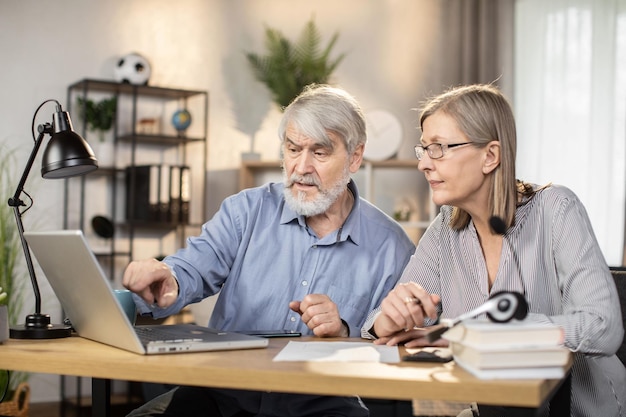 Senior people working together from home via computer