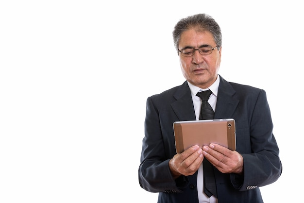 senior Persian businessman using digital tablet