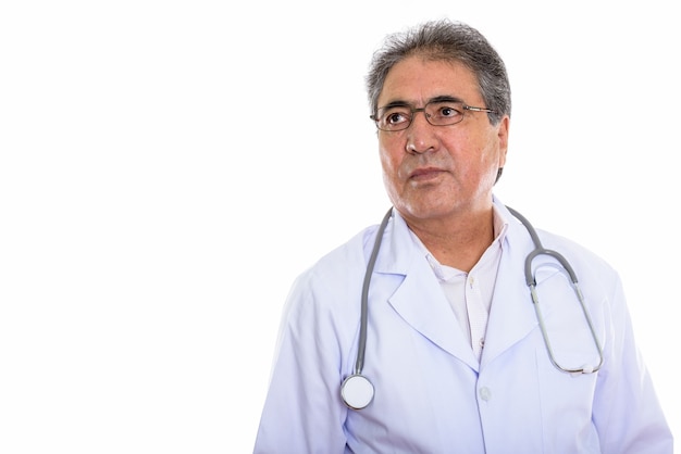 senior Persian man doctor thinking while looking at copyspace