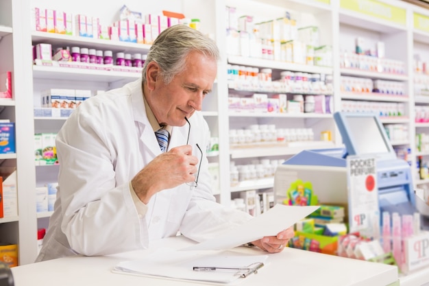 Senior pharmacist reading prescription