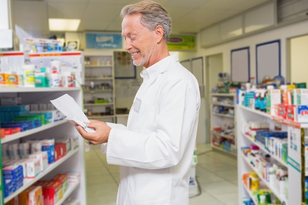 Senior pharmacist reading prescription