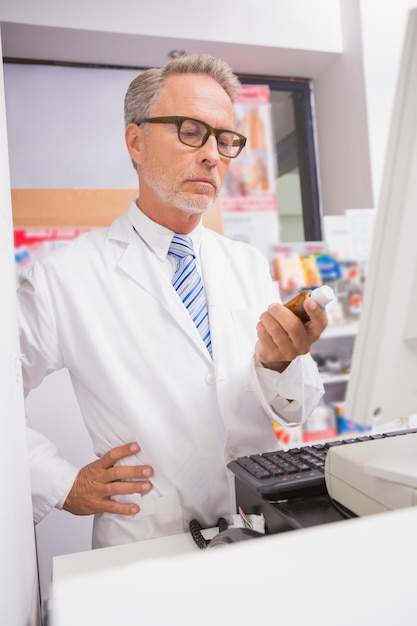 Senior pharmacist using the computer