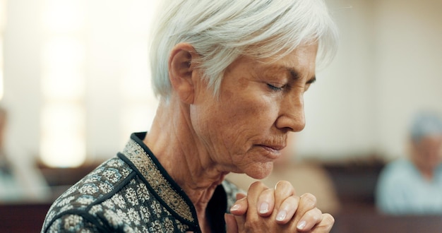 Senior prayer or old woman in church for God holy spirit or religion in cathedral or Christian community Faith spiritual or face of elderly person in chapel or sanctuary to praise Jesus Christ