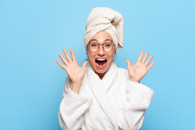 Senior pretty woman after shower wearing bathrobe