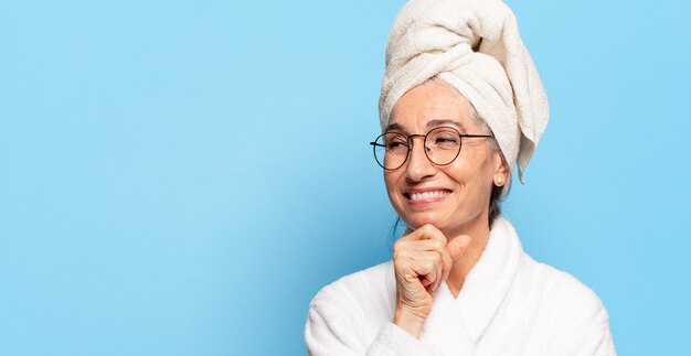 Senior pretty woman after shower wearing bathrobe