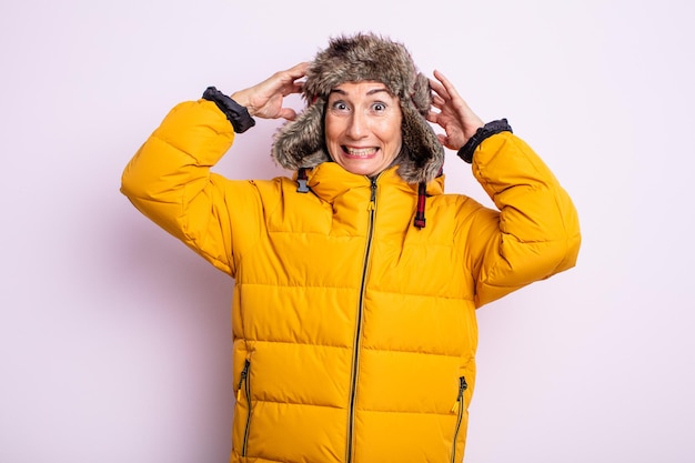 Senior pretty woman feeling stressed, anxious or scared, with hands on head. winter concept