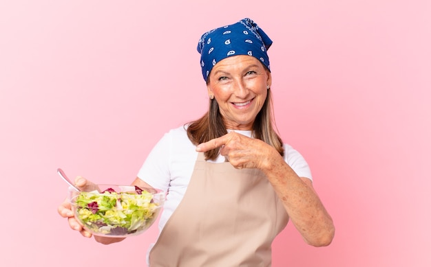 Senior pretty woman preparing a salad