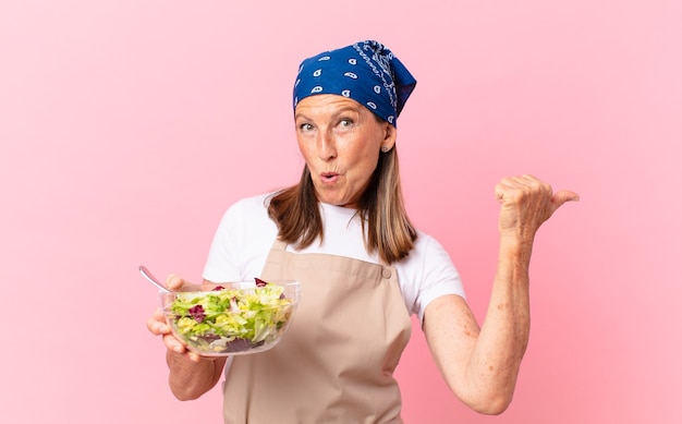 Senior pretty woman preparing a salad