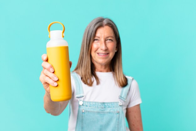 Senior pretty woman with a coffee thermos