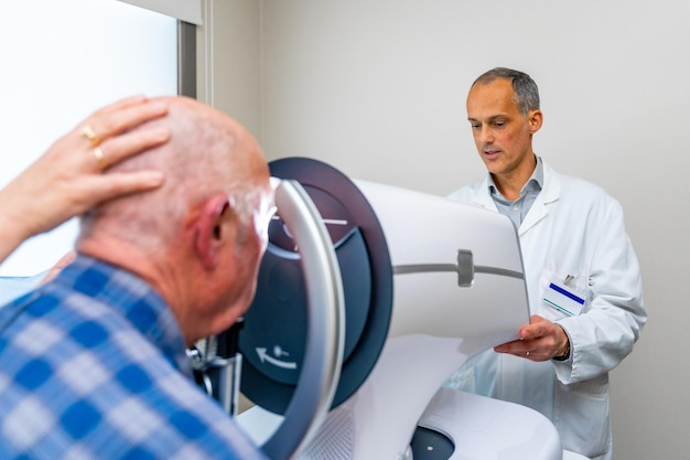 Senior receiving a laser treatment for glaucoma in the eye