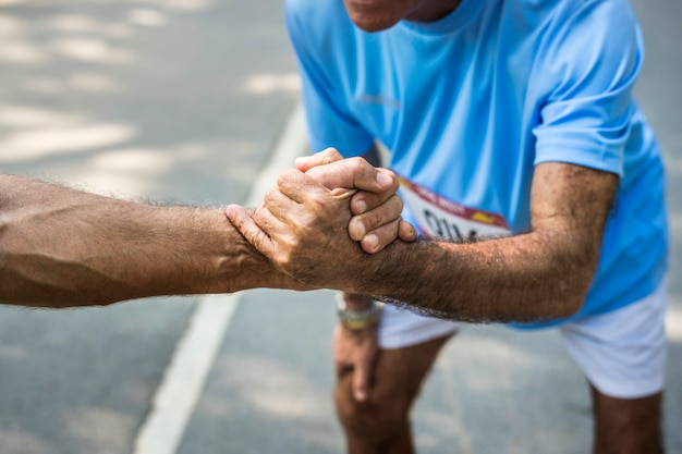 Senior runner giving a helping hand