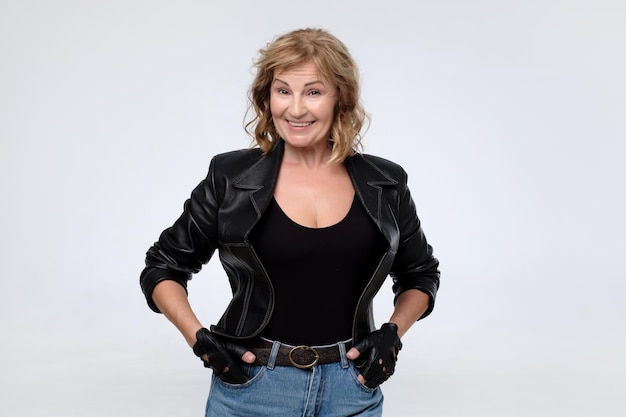 Senior smiling woman in leather jacket Studio shot