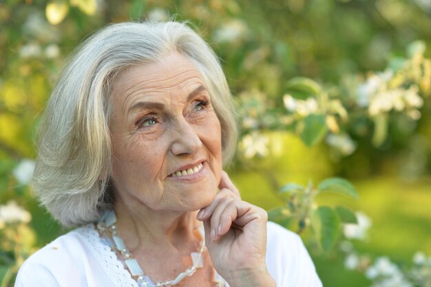 Senior smilling beautiful woman posing in spring park