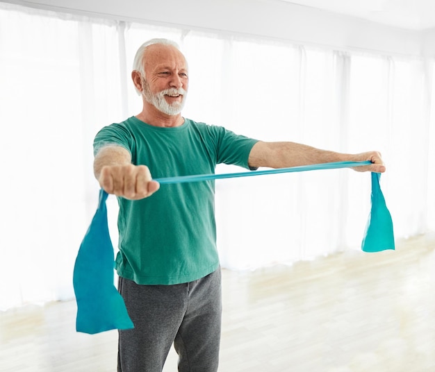 Senior stretching exercise and doing yoga at home