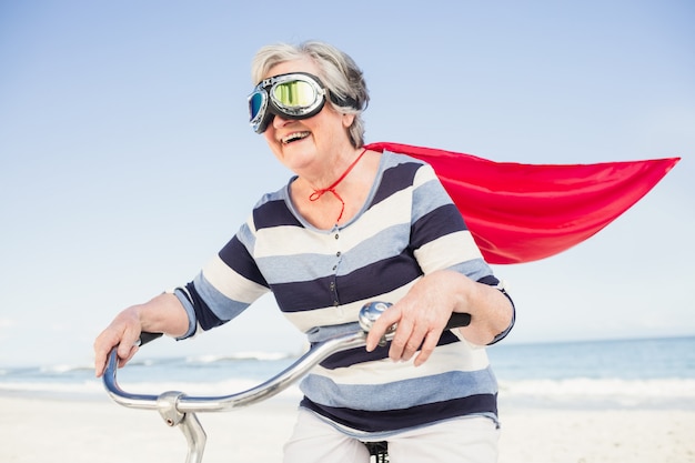 Senior superwoman on a bike