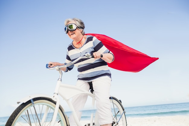 Senior superwoman on a bike