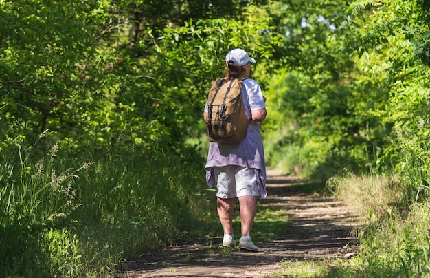 Senior tourist woman on a forest background. Healthy lifestyle.Hiking.