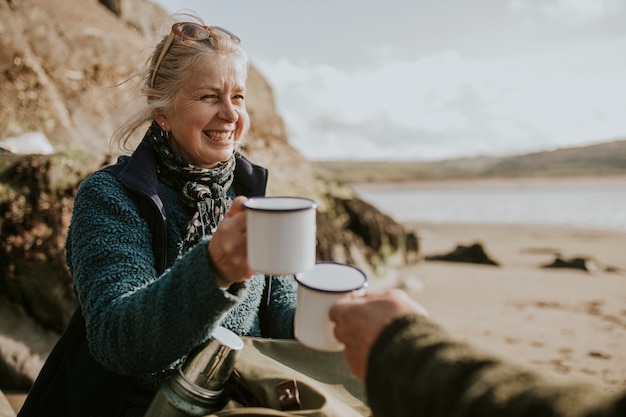 Senior vrouw camper met een koffiemok met ontwerpruimte