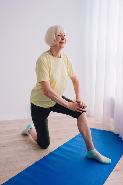 senior vrouw doet yoga indoor Anti age sport yoga concept