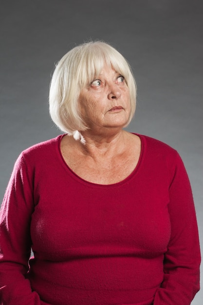 senior woman against gray background