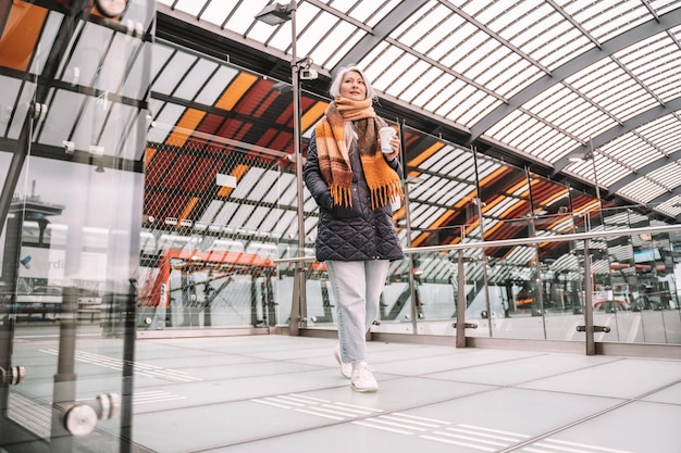 Senior woman are waiting for the train in a station