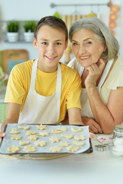 Senior woman and boy baking delicious cookies