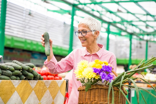 Senior woman buying  on market