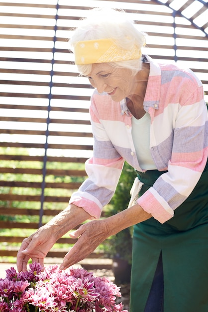 Senior Woman Caring for Flowers