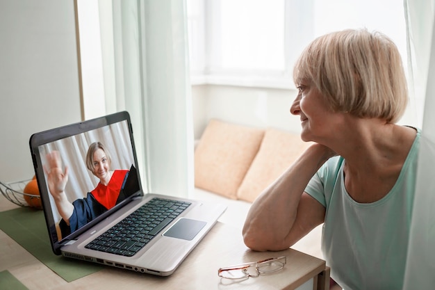 Senior woman congratulating daughter during online video call