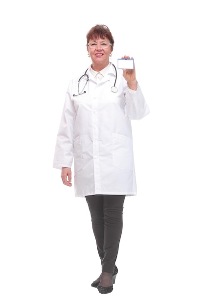 Senior woman doctor showing business card on a white background and looking at camera