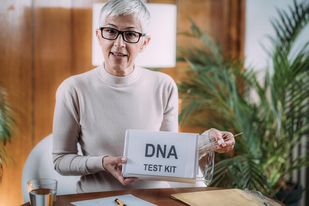 Senior Woman Doing a Mailed DNA Test at Home