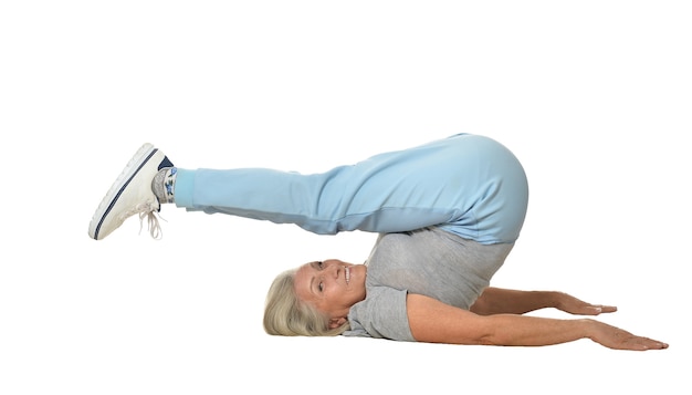 Senior woman exercising  on a white background