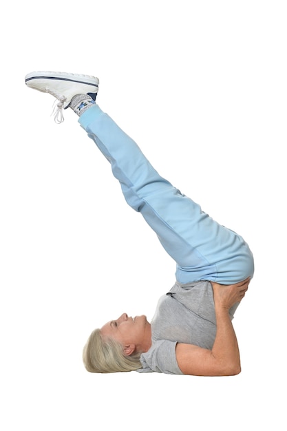 Senior woman exercising  on a white background