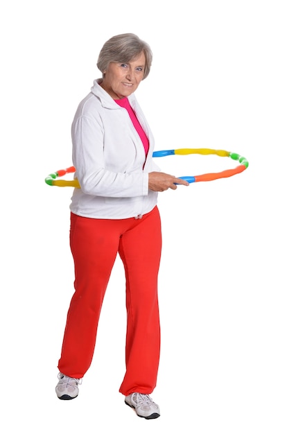 Senior woman exercising with dumbbell on white background