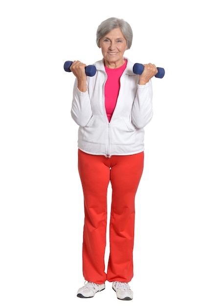 Senior woman exercising with dumbbells on white background