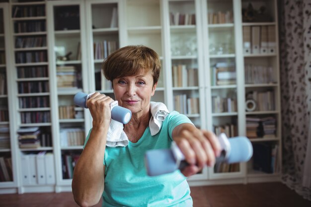 Senior woman exercising with dumbbells