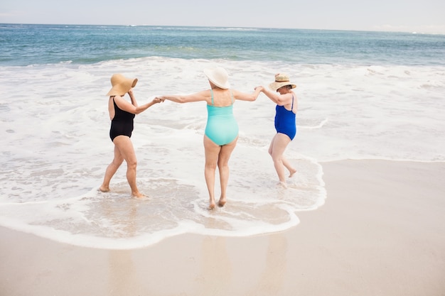 Senior woman friends playing in water