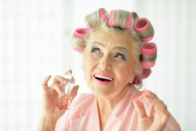 Senior woman in  hair rollers  at home