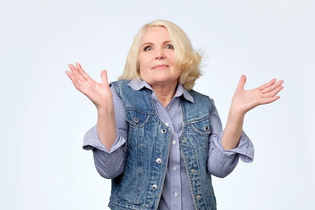 Senior woman having a doubting gesture