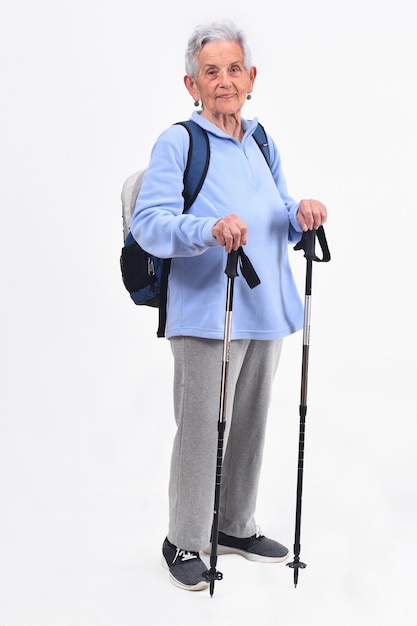 Senior woman hiker on white background
