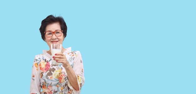 Senior woman holding a glass of milk