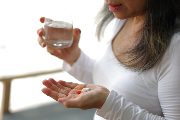 senior woman at home taking medicine