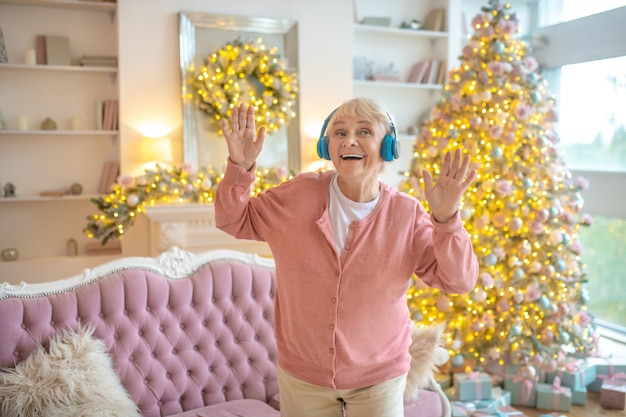 Senior woman listening to music in headphones