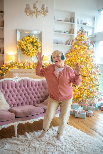 Senior woman listening to music in headphones